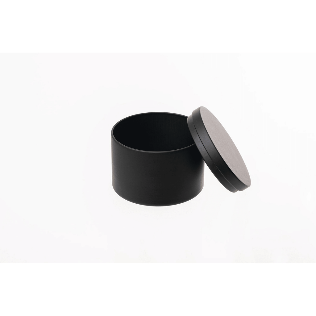 Black cylindrical container with a black lid on a white background