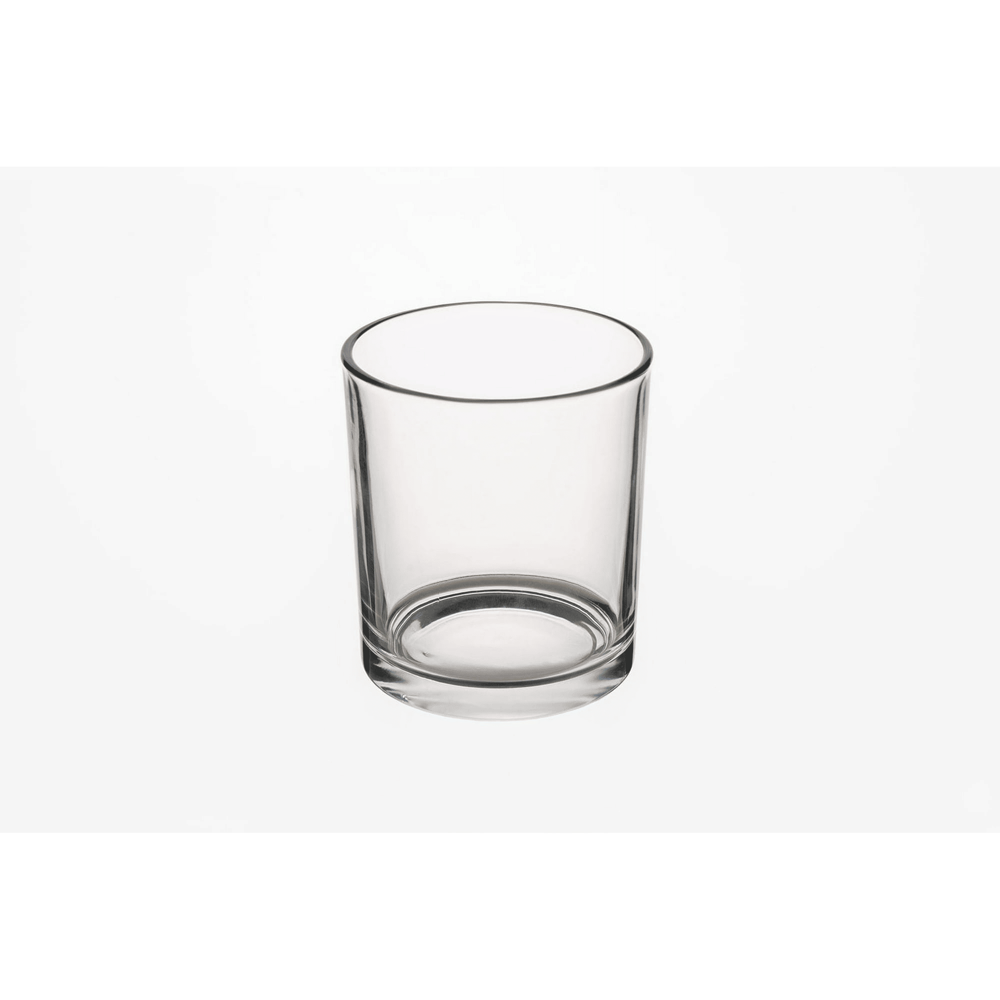 Empty clear glass candle jar on a white background