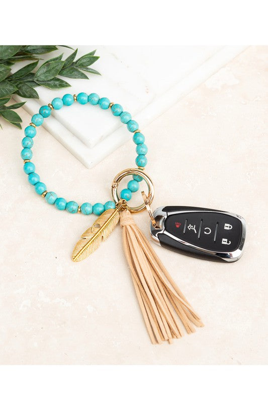 Turquoise stone bangle key ring bracelet with cream suede tassel and feather charm - boho hands-free key holder jewelry