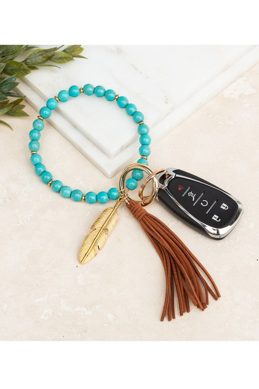 Turquoise stone bangle key ring bracelet with cognac suede tassel and feather charm - boho hands-free key holder by Hailey Brook Designs