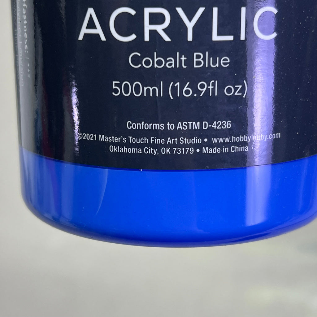 Close-up of Master's Touch Cobalt Blue acrylic paint label showing technical details and product information on blue background - paint specifications