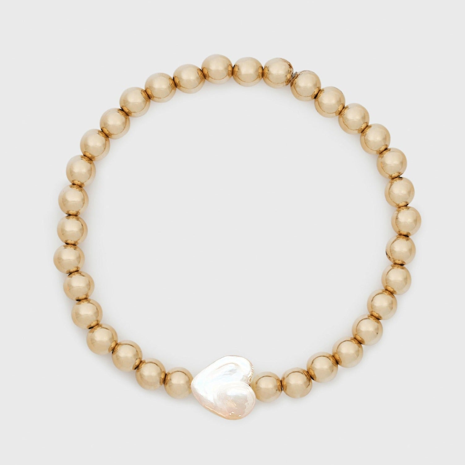 Gold beaded bracelet with heart-shaped baroque pearl charm on light gray background for Valentine's Day gift showing 14K gold filled 5mm beads