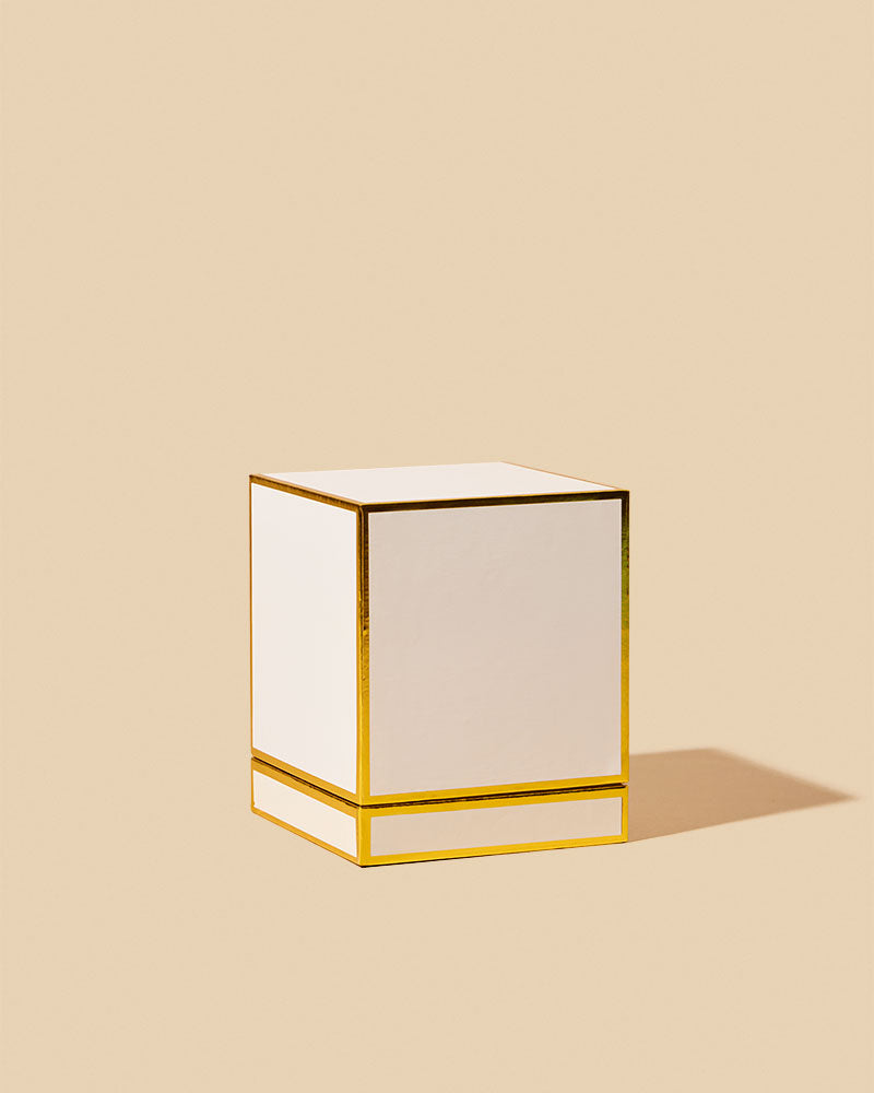 Gloss Porcelain white rigid square candle box with gold-accented edges on beige background - premium gift box for handmade candles