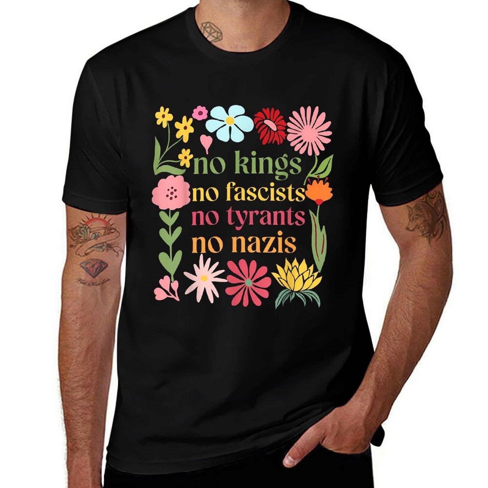 Man wearing black stretchy t-shirt with colorful floral design and "no kings no fascists no tyrants no nazis" text on white background