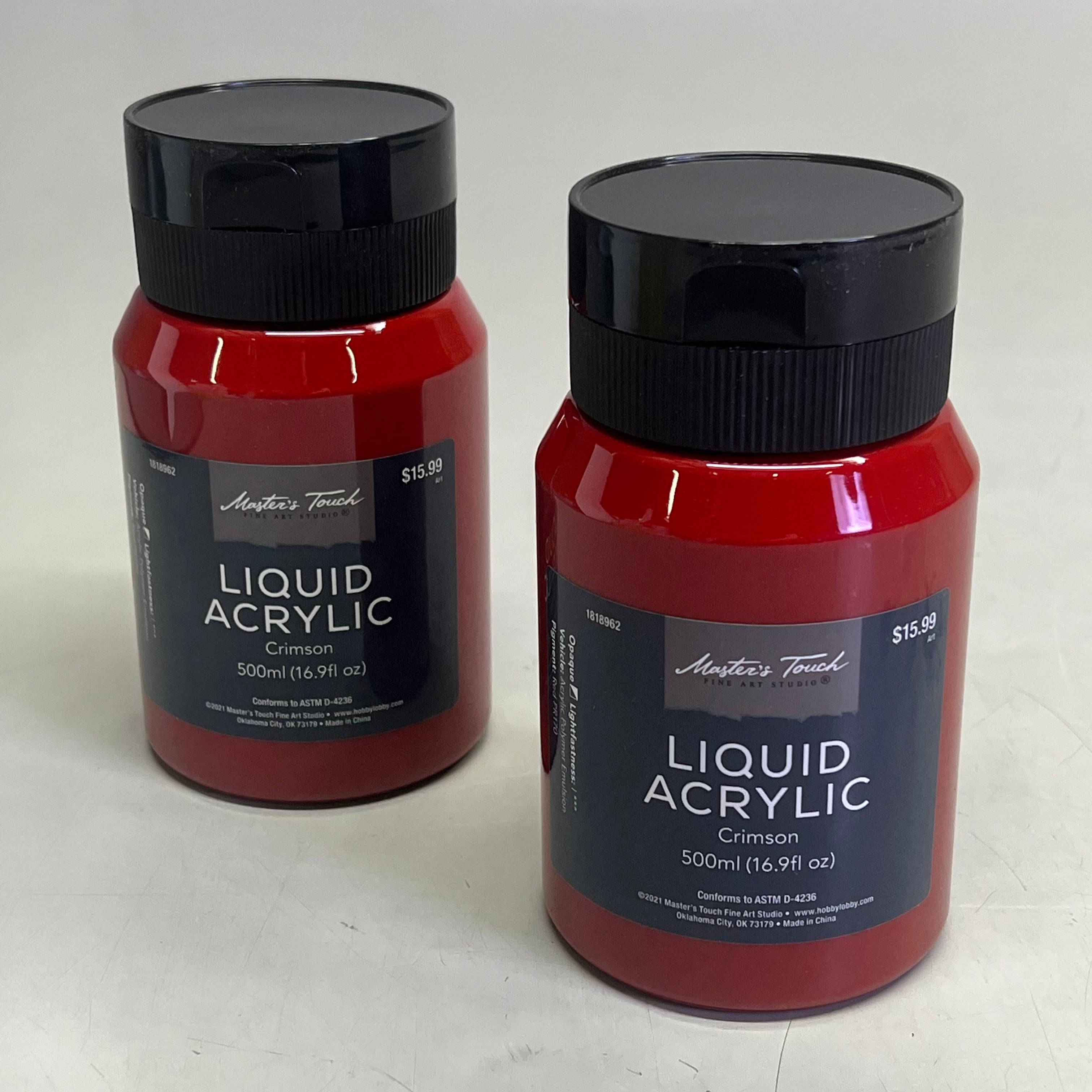Two bottles of Master's Touch Liquid Acrylic Crimson paint in transparent plastic bottles showing red paint color on light gray background - 2 pack acrylic paint set