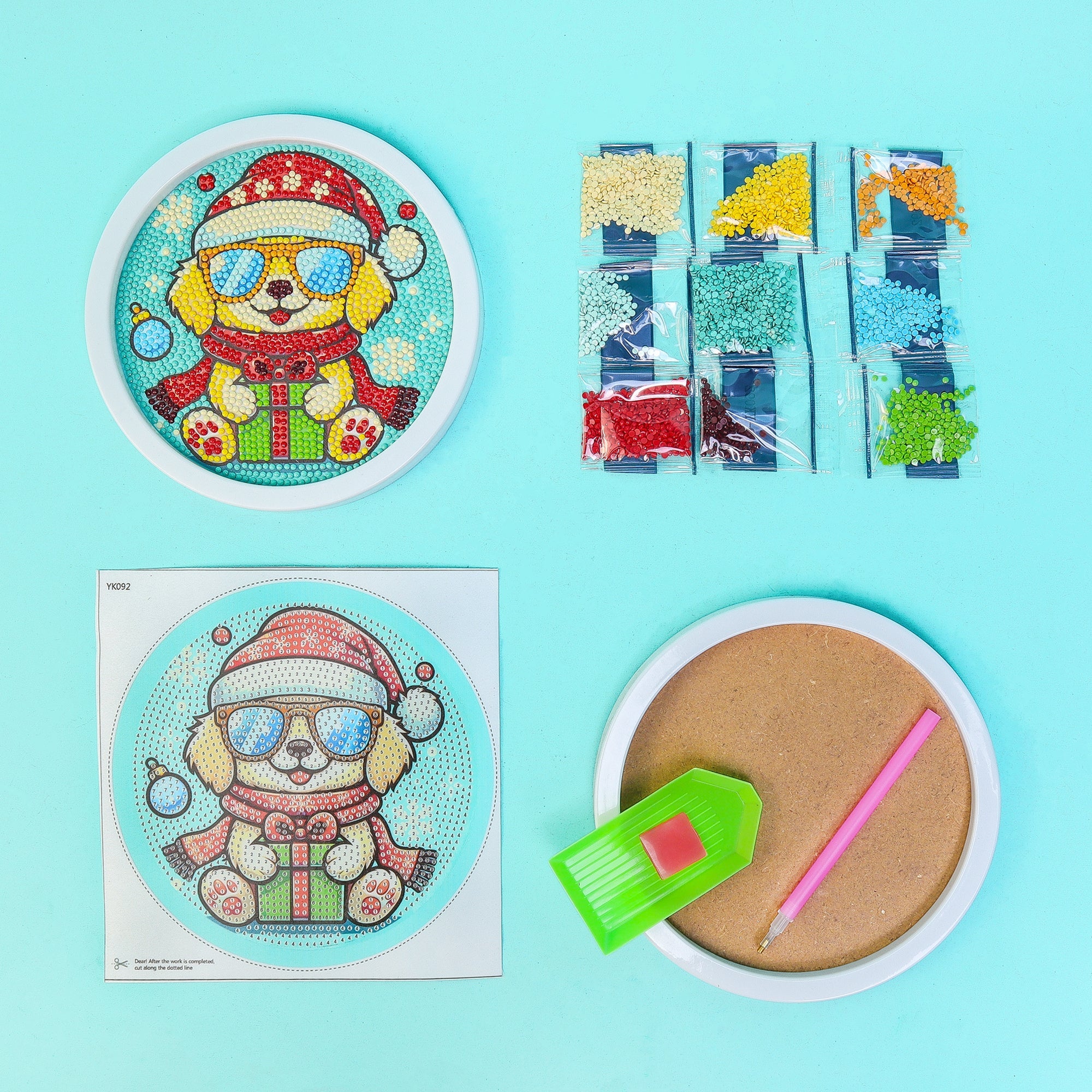 Diamond art craft kit materials with dog wearing a Santa hat design, and tools on a blue background