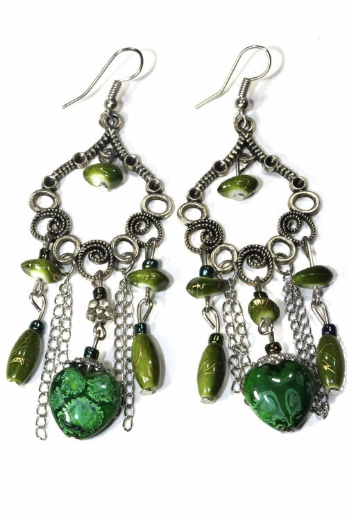 Pair of green marbled bead dangle earrings with silver scroll work and chains on white background