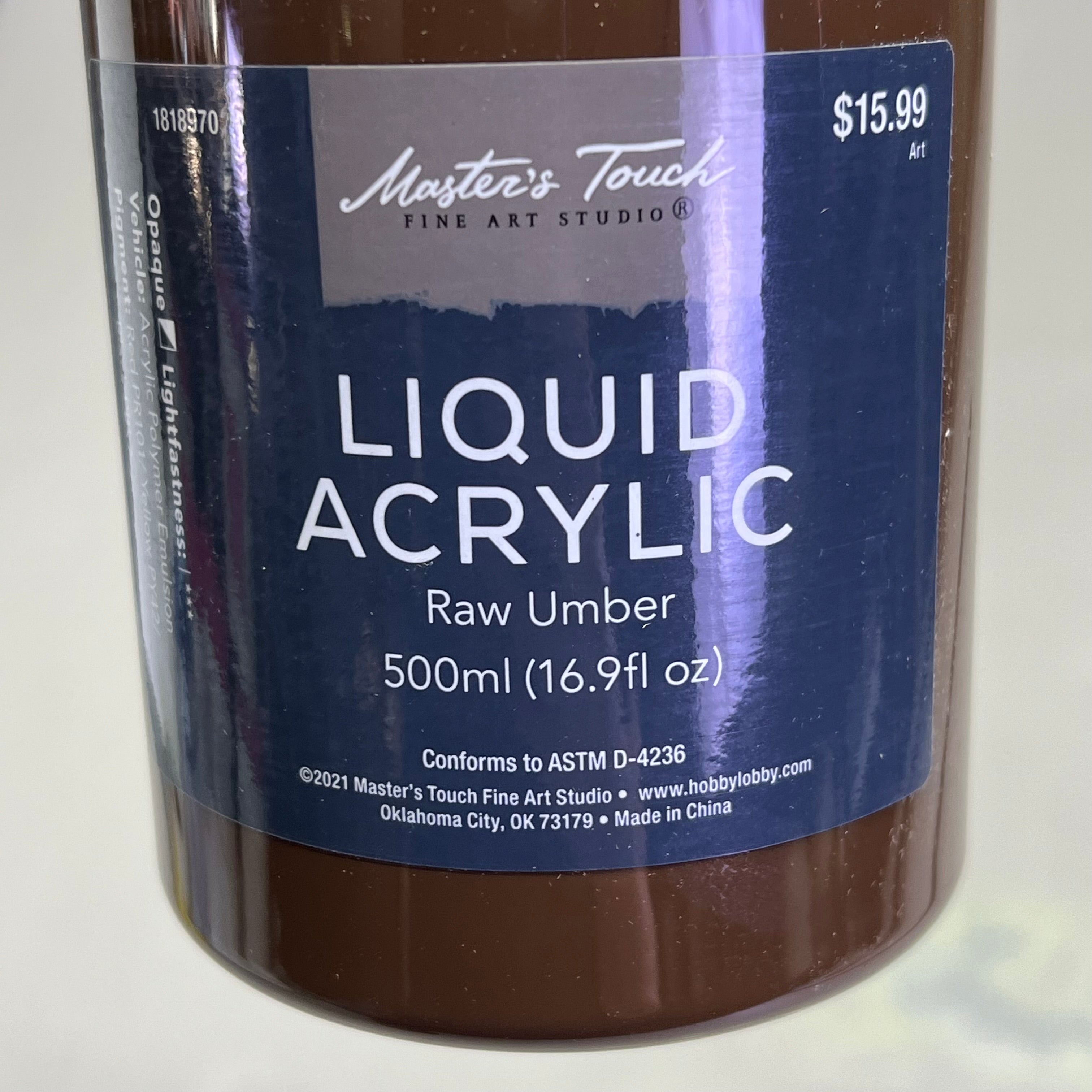 Close up of Master's Touch Liquid Acrylic Paint label showing Raw Umber 16.9 fl oz on white background - artist acrylic paint