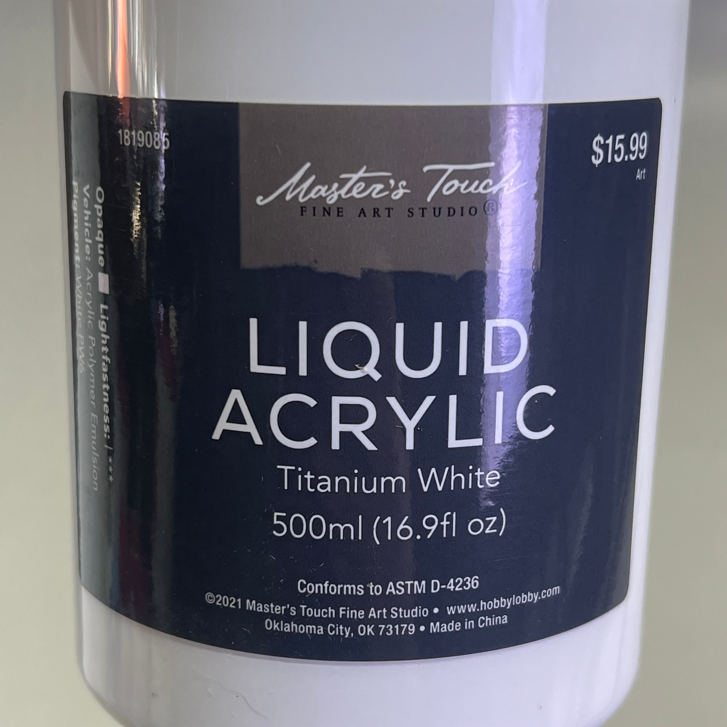Close up of Master's Touch Liquid Acrylic Paint label showing Titanium White 16.9 fl oz on white background - artist acrylic paint