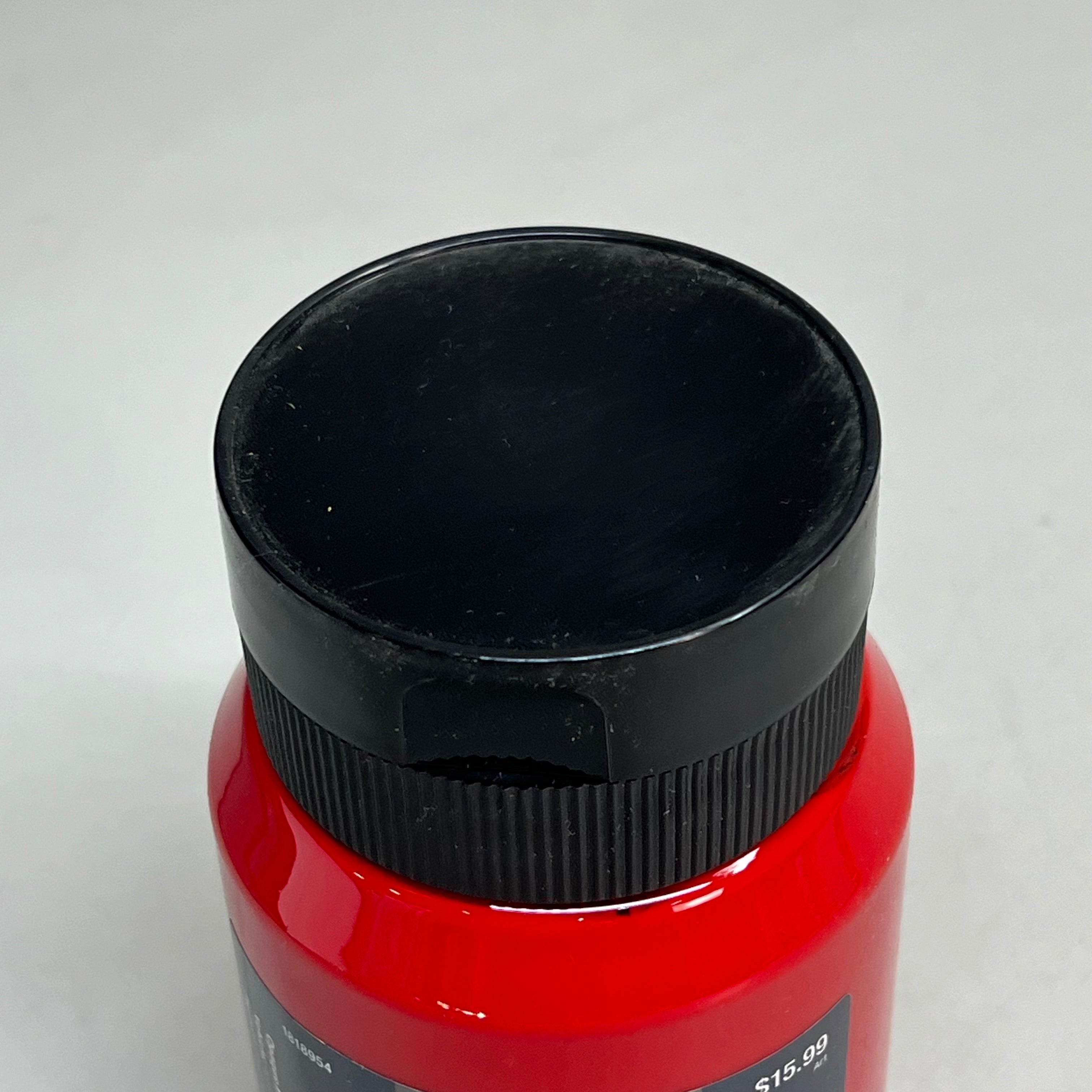 Close up of black bottle cap on Master's Touch red acrylic paint bottle on white background - permanent red acrylic