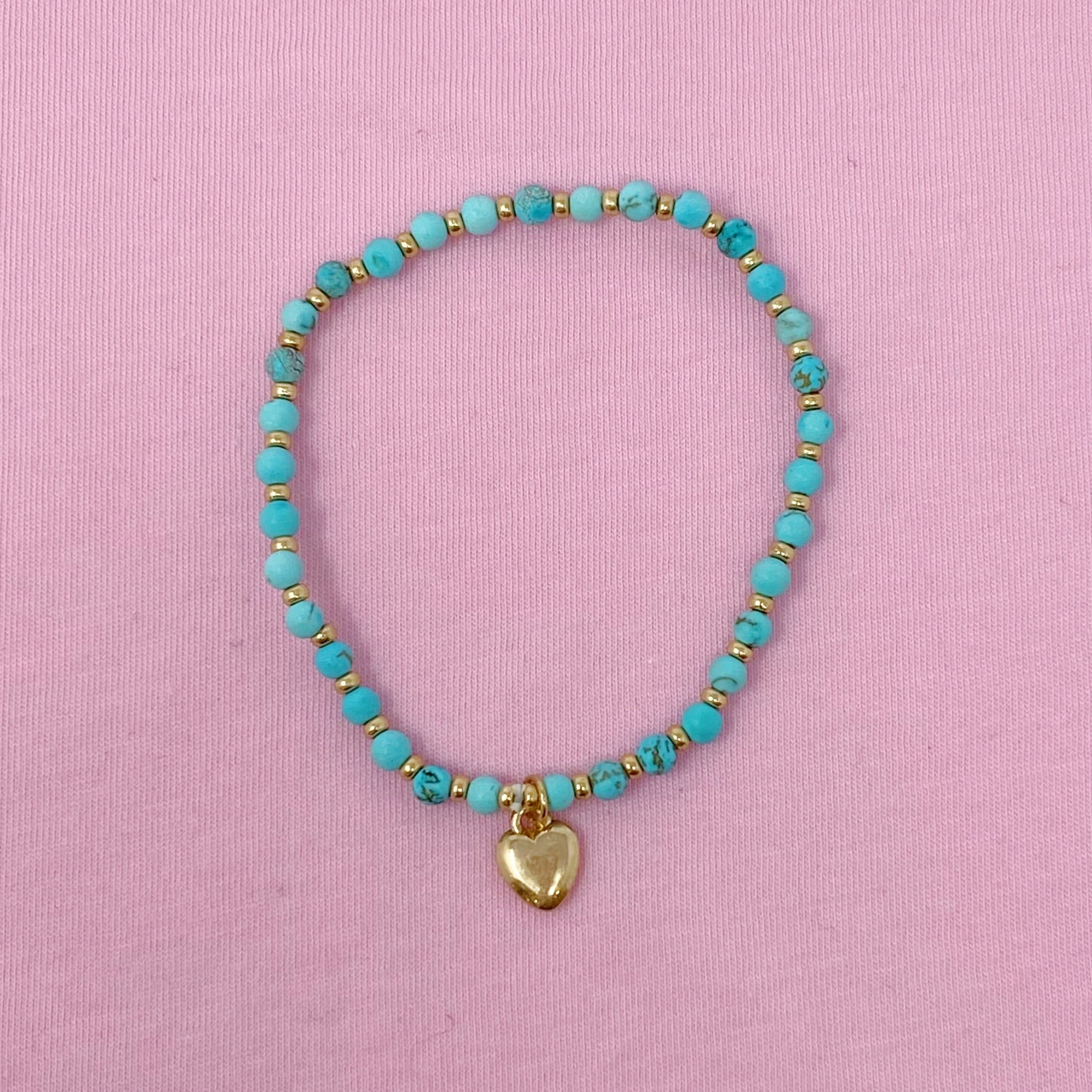 Turquoise stone beaded anklet with gold heart charm on pink background - natural gemstone Valentine's Day gift
