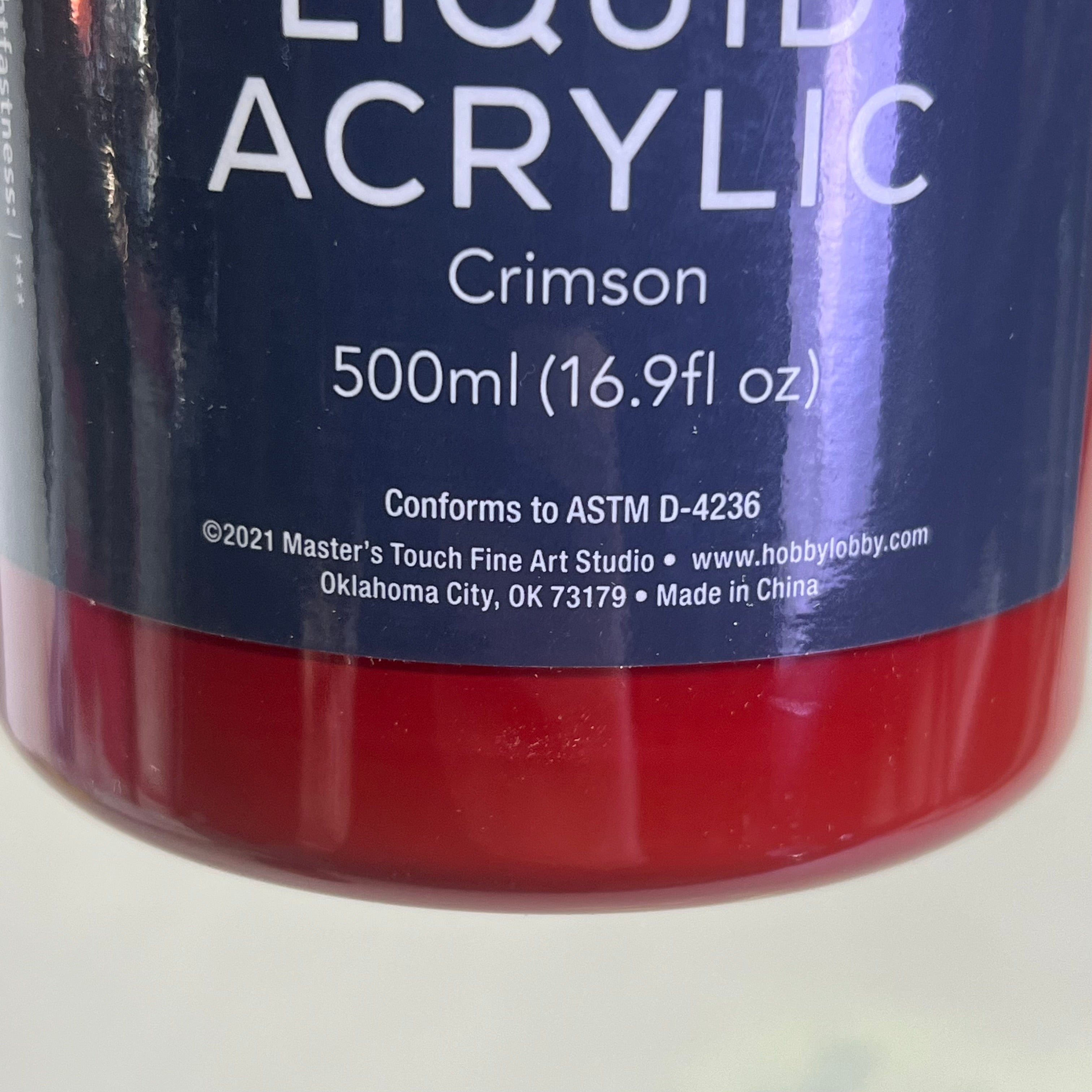 Master's Touch Liquid Acrylic Crimson paint bottle with blue label showing red paint color through transparent plastic bottle - artist acrylic paint