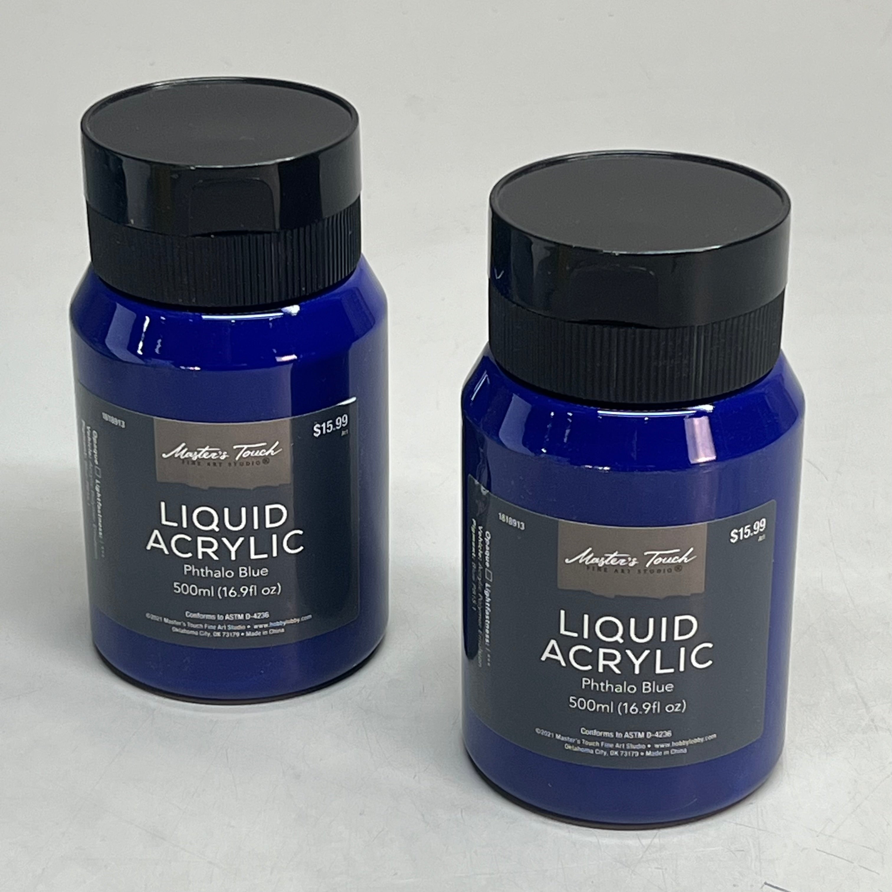 Two bottles of Master's Touch Liquid Acrylic Phthalo Blue paint in transparent plastic bottles showing dark blue paint color on gray background - 2 pack acrylic paint set