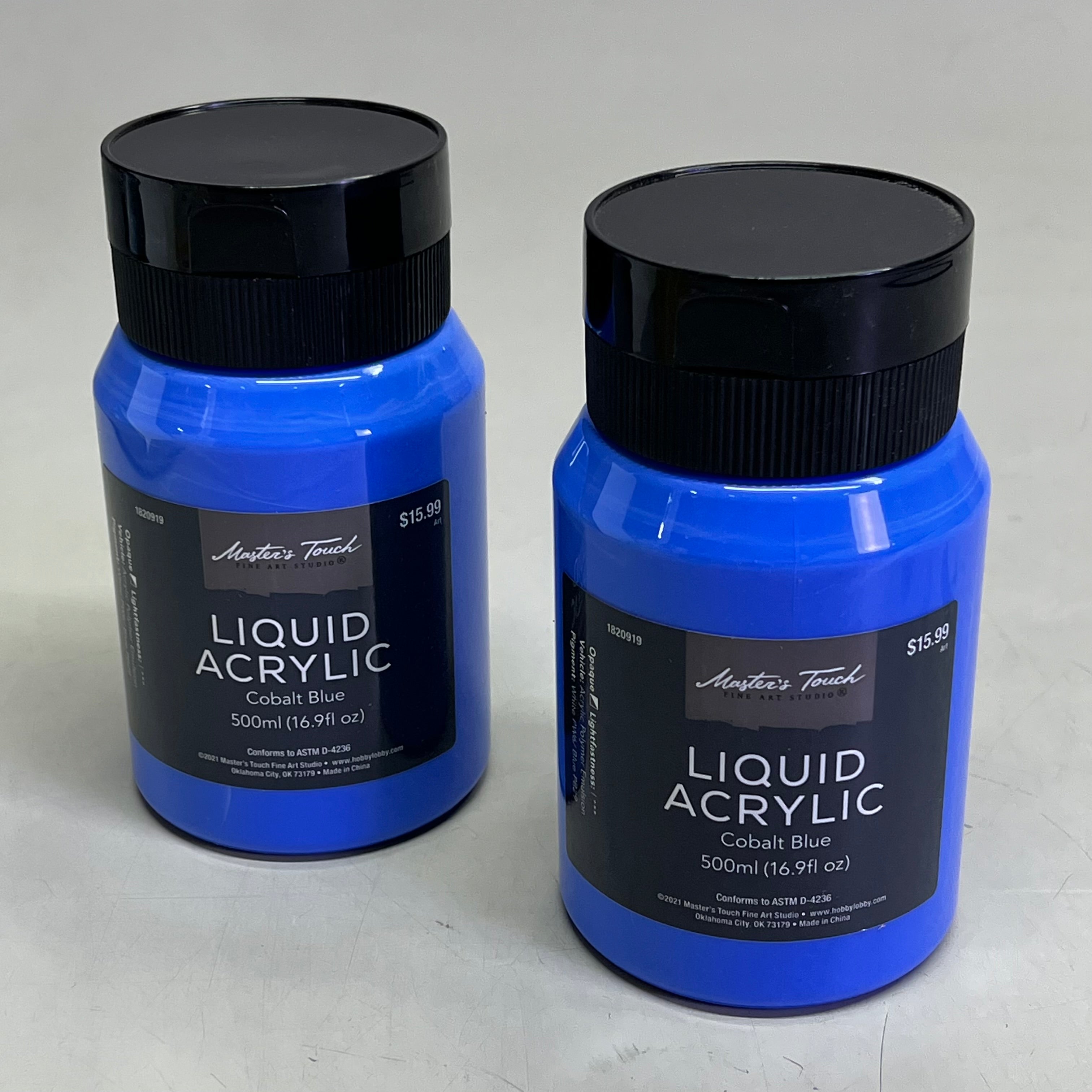 Two bottles of Master's Touch Liquid Acrylic Cobalt Blue paint in transparent plastic bottles showing blue paint color on light gray background - 2 pack acrylic paint set