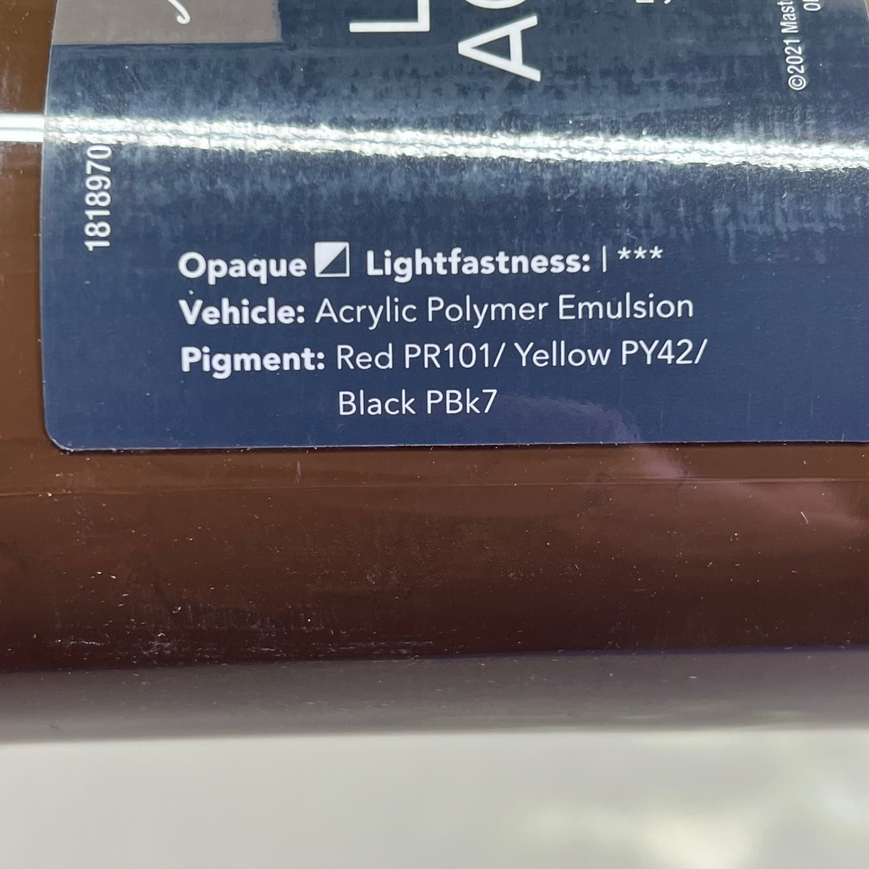 Close-up of brown paint label side with color information - Master's Touch Raw Umber acrylic paint details