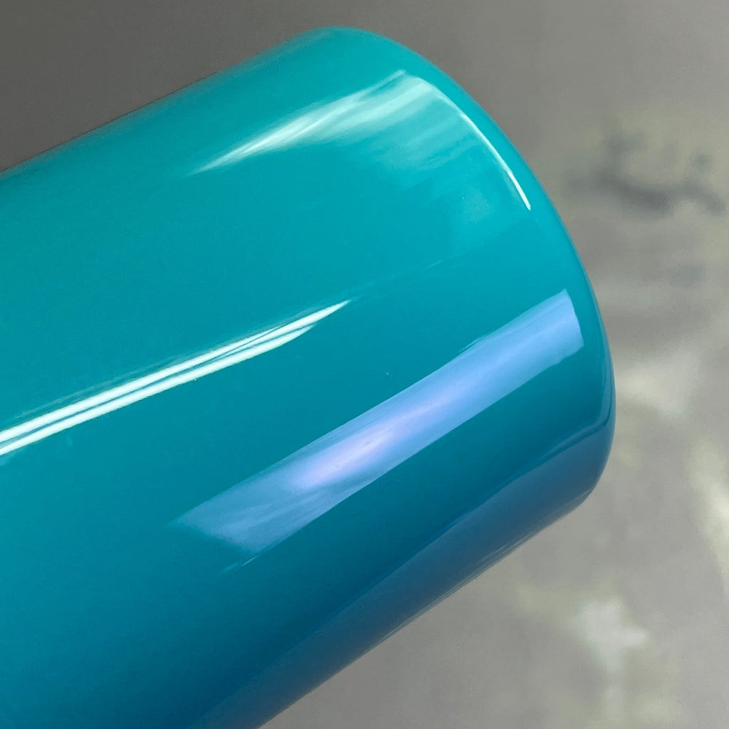Bottom view of Master's Touch Viridian acrylic paint bottle showing blue-green turquoise paint color through transparent plastic container - bottle base detail