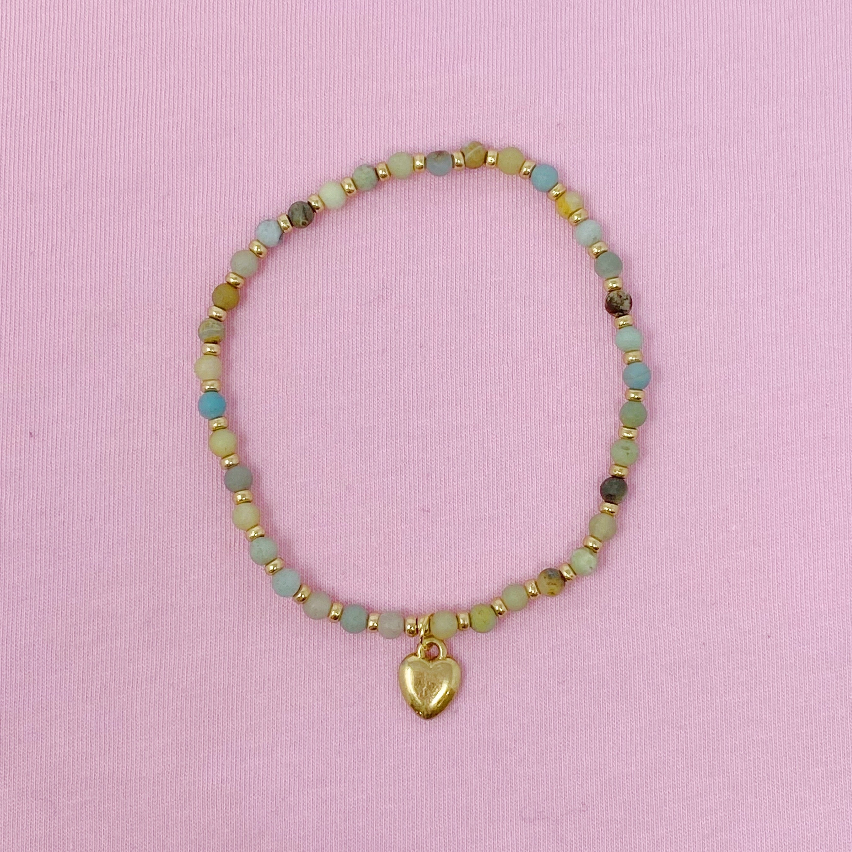 Multi-colored amazonite beaded anklet with gold heart charm on pink background - natural stone Valentine's Day jewelry