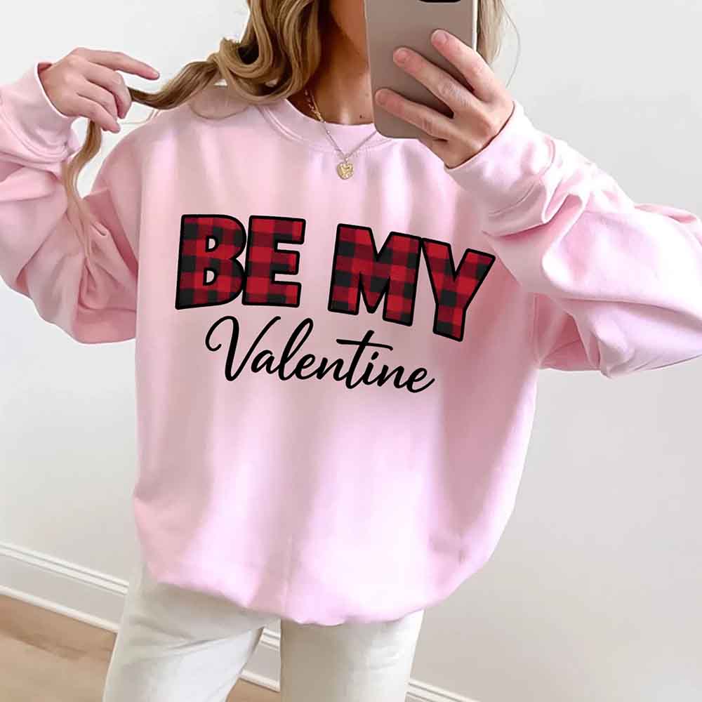 Person wearing pink Be My Valentine buffalo plaid crewneck sweatshirt taking selfie - Valentine's Day gift