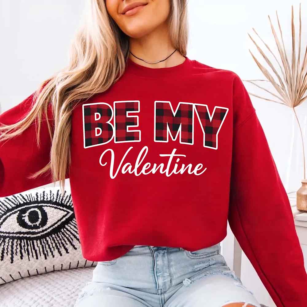 Person wearing red Be My Valentine crewneck sweatshirt sitting on couch - Valentine's Day outfit