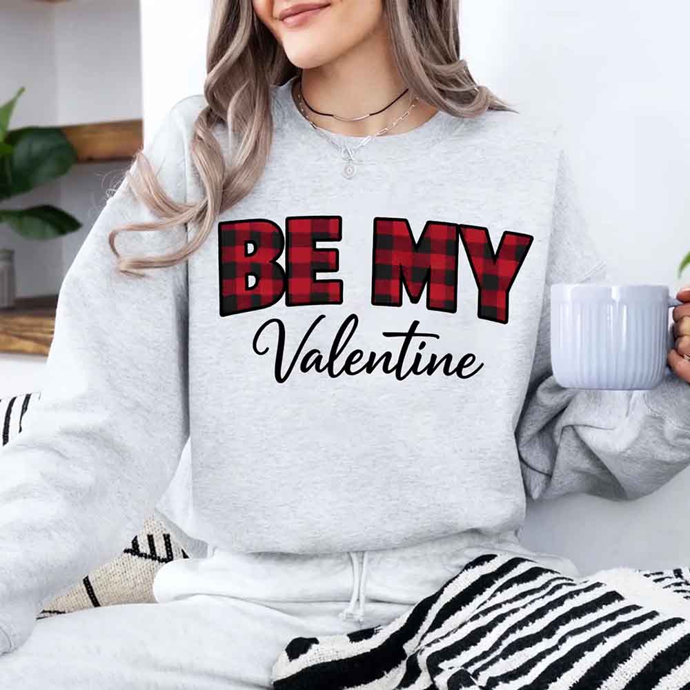 Person wearing ash gray Be My Valentine crewneck sweatshirt holding mug - Valentine's Day loungewear