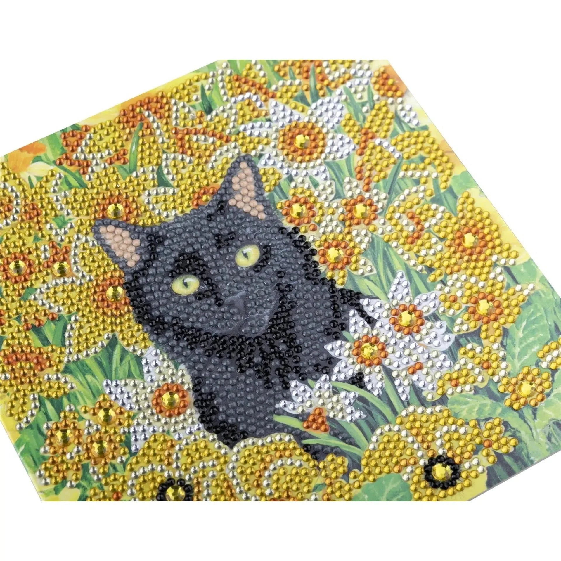 Diamond painting with a black cat surrounded by yellow and white flowers on a white background