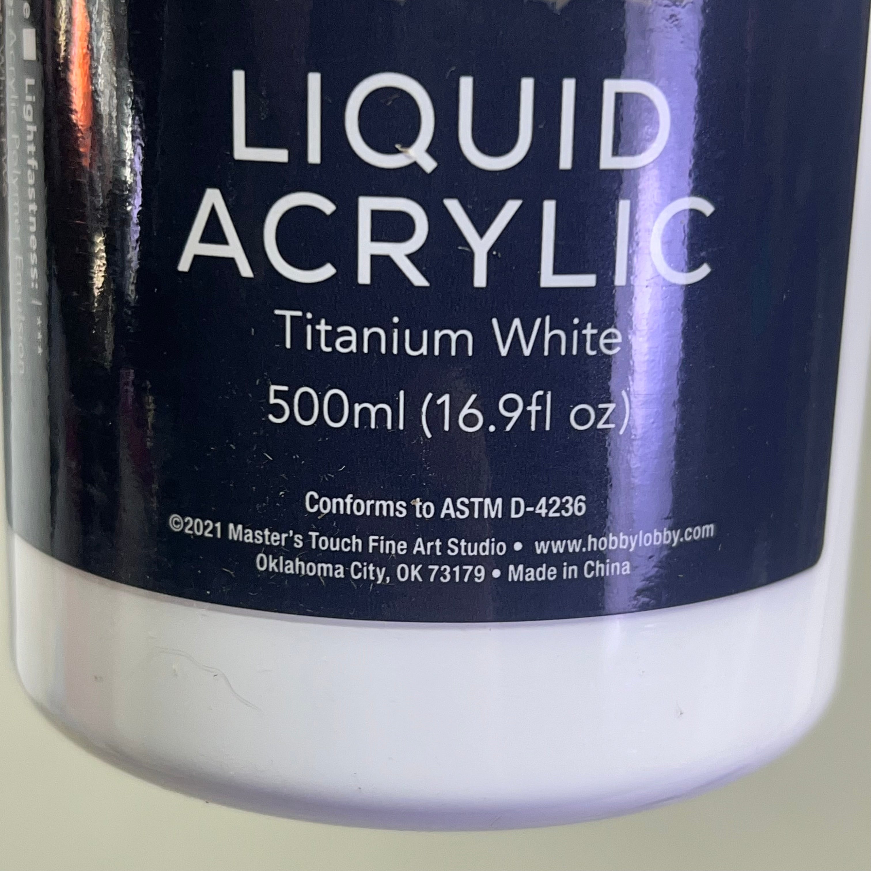 Bottom of Master's Touch Liquid Acrylic Paint label showing Titanium White 500ml 16.9 fl oz on white bottle