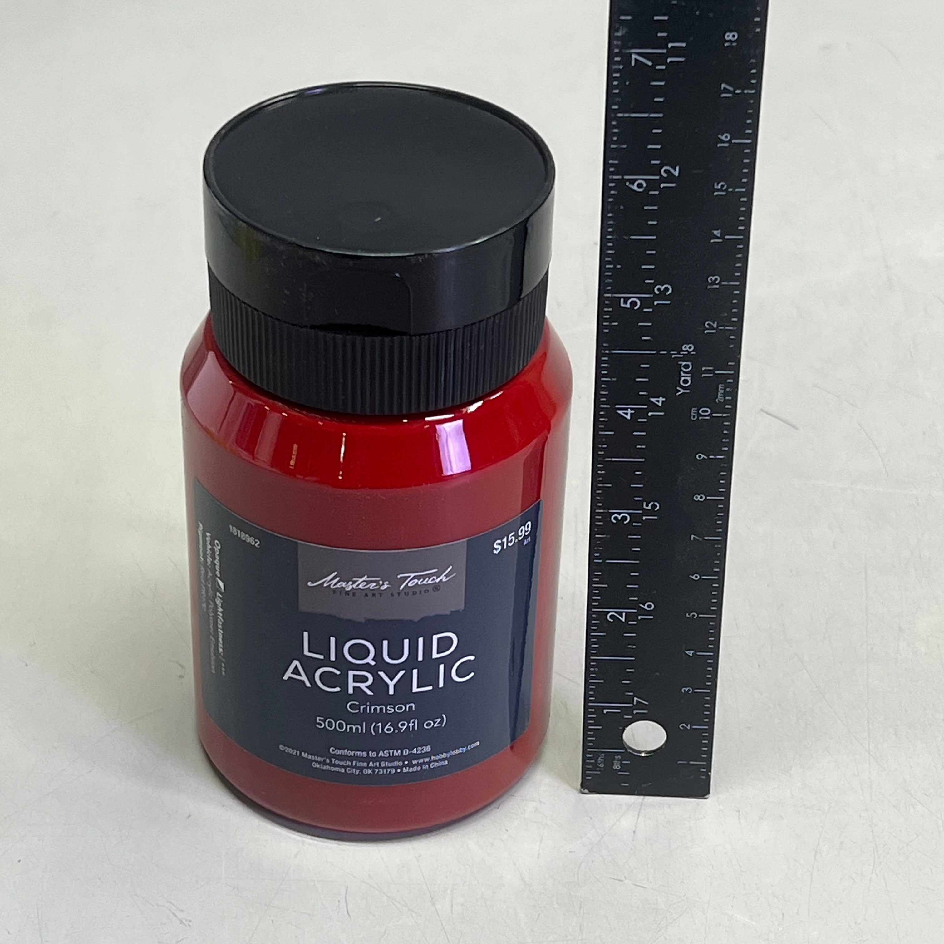 Master's Touch Liquid Acrylic Crimson paint bottle with black lid next to ruler showing size comparison on white background - 16.9 fl oz acrylic paint