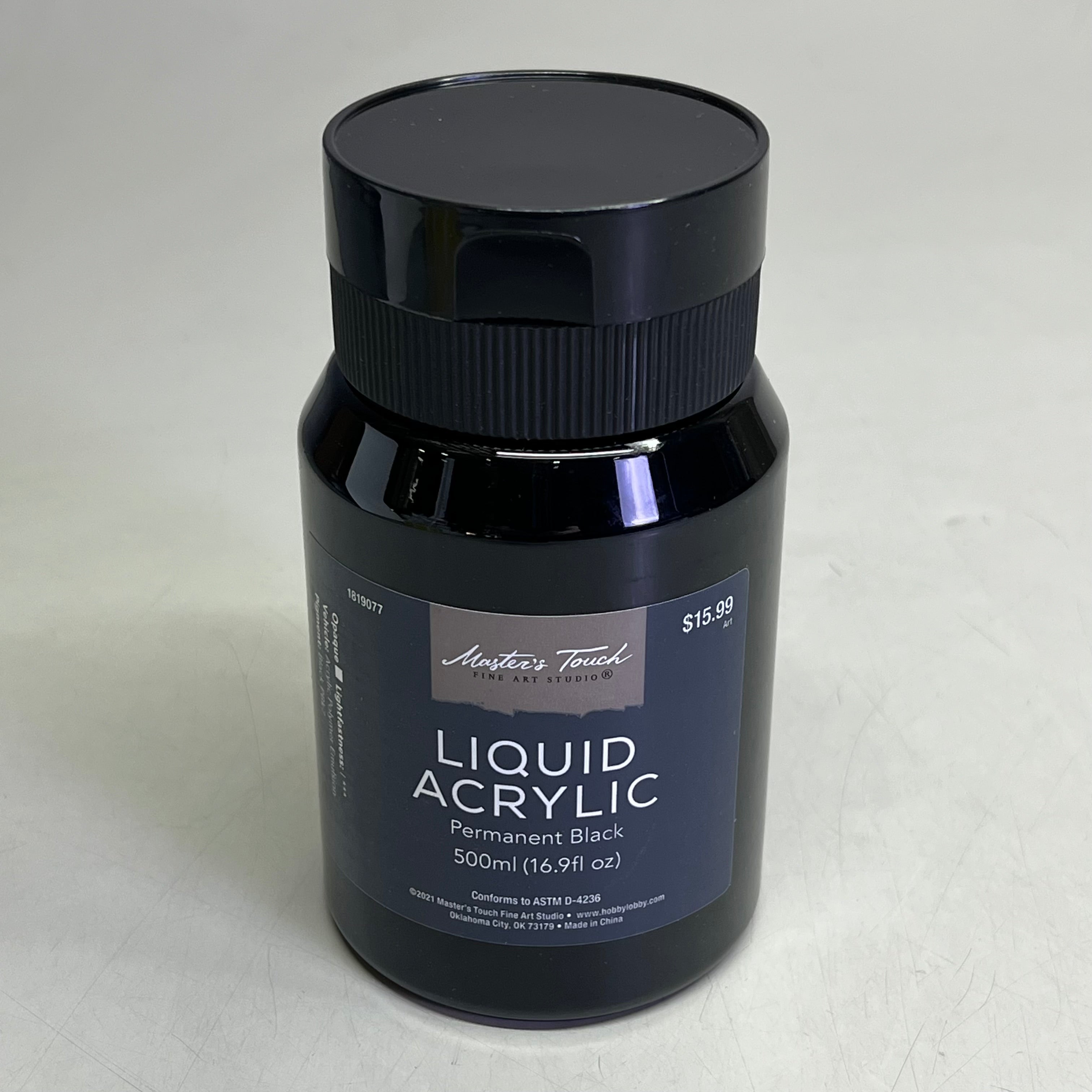 Black bottle of Master's Touch Liquid Acrylic Paint with label showing Permanent Black 16.9 fl oz on light gray background
