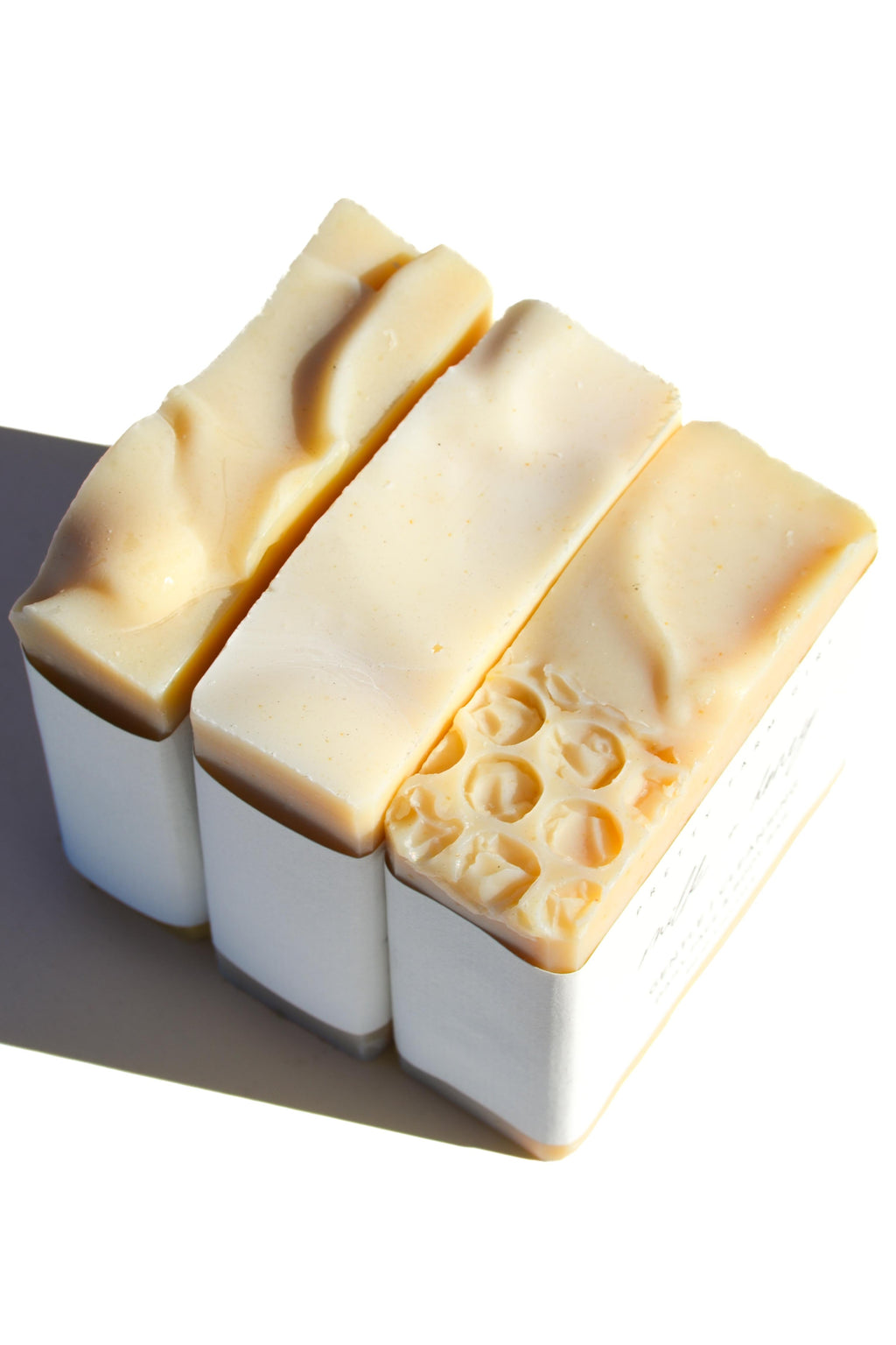 Fragrance-free tallow goat milk soap trio - three natural handmade bars with distinct textures closeup