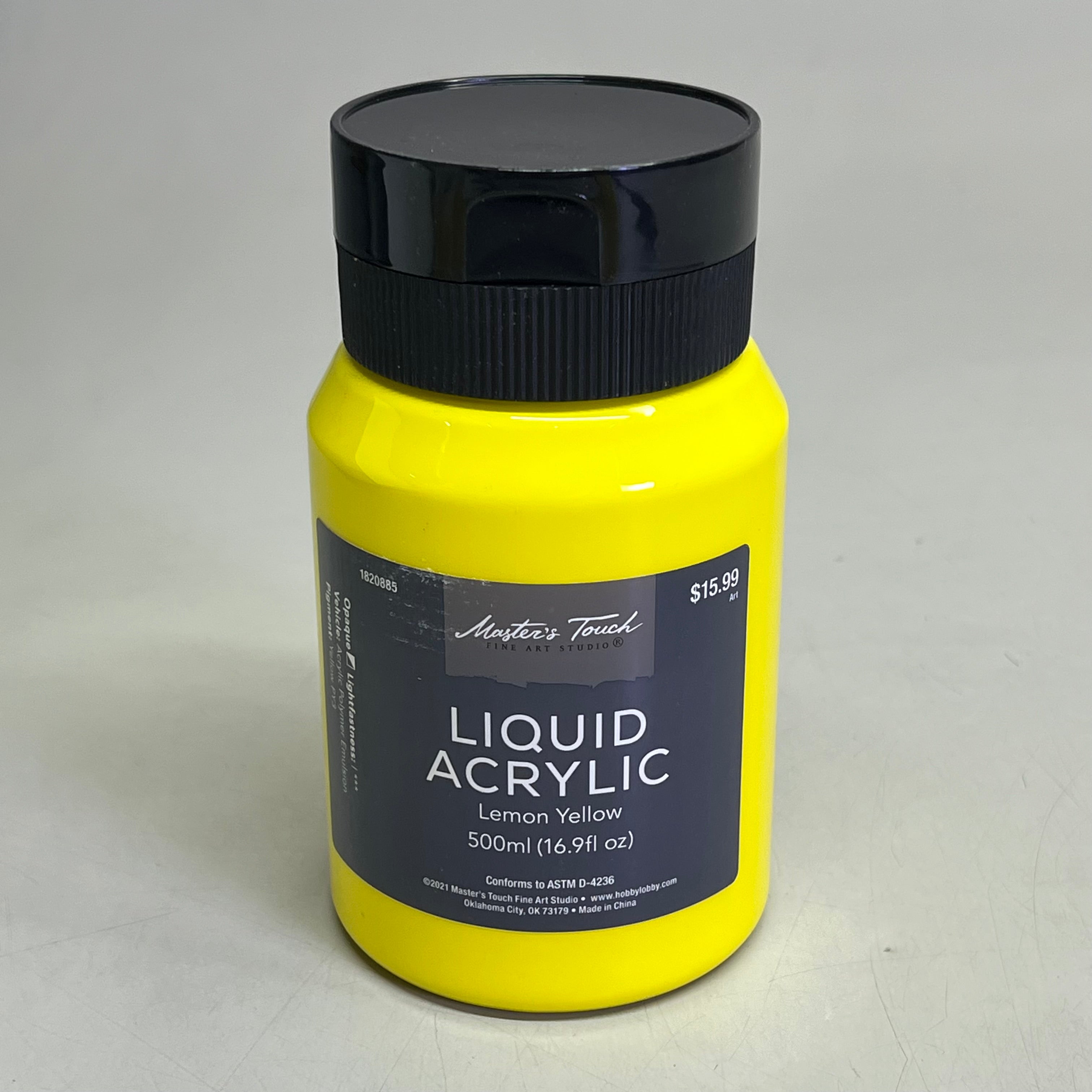 Yellow bottle of Master's Touch Liquid Acrylic Paint with black lid showing Lemon Yellow 16.9 fl oz on gray background