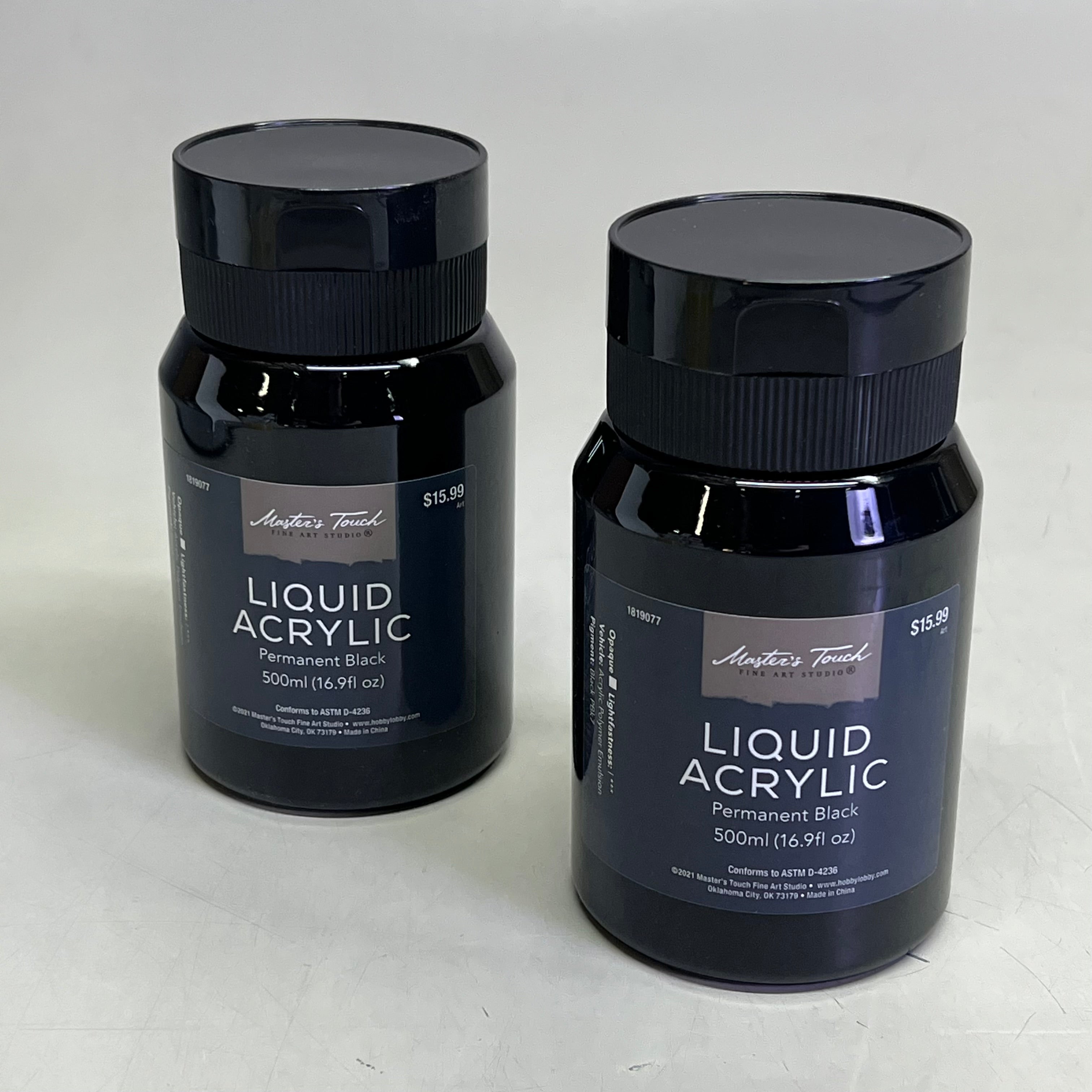 Close up of two bottles of Master's Touch Liquid Acrylic Paint in Permanent Black 16.9 fl oz on light gray background - 2 pack artist paint