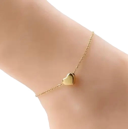 Gold waterproof puffed heart anklet on ankle against white background - 18K gold plated Valentine's Day jewelry