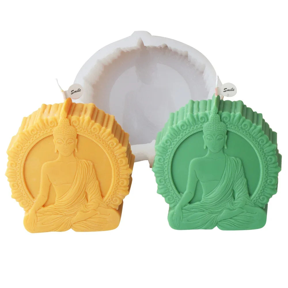 Silicone mold with two Buddha design candles in yellow and green on white background - candle making mold