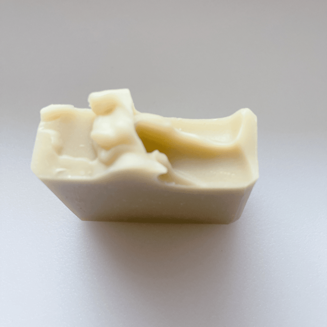 Handcrafted bar of Artisanal Aleppo Style Soap showing rustic edge end view on white background