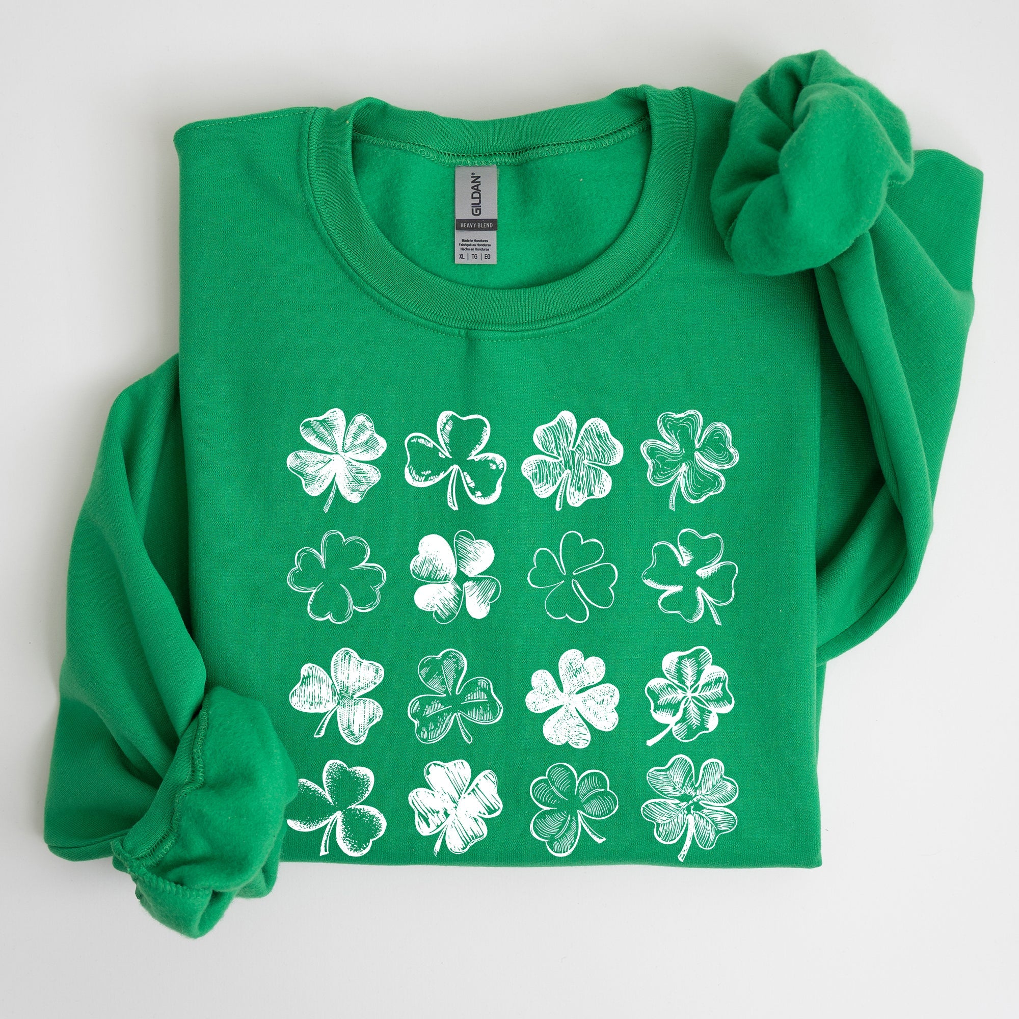Irish Green long-sleeve shirt with white four-leaf clover patterns on a white background
