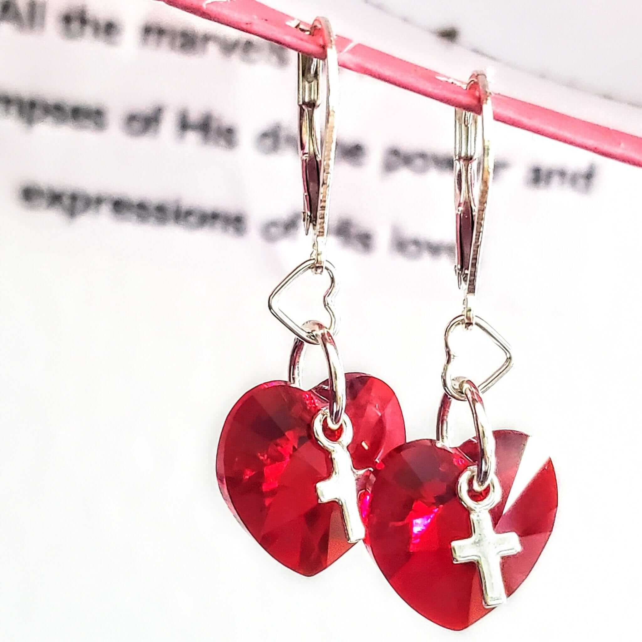 Heart-shaped earrings with red Swarovski crystals and cross charms on pink background - Sterling Silver I Love You Jesus Christian earrings