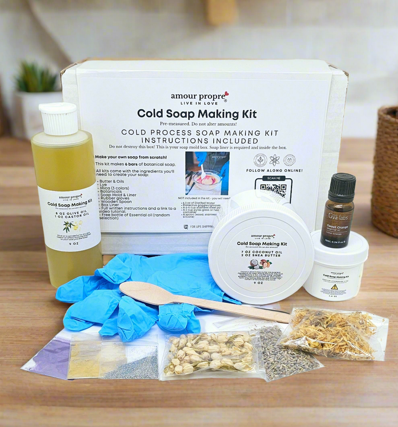 closeup of Cold Soap Making Kit with contents displayed on a wooden surface