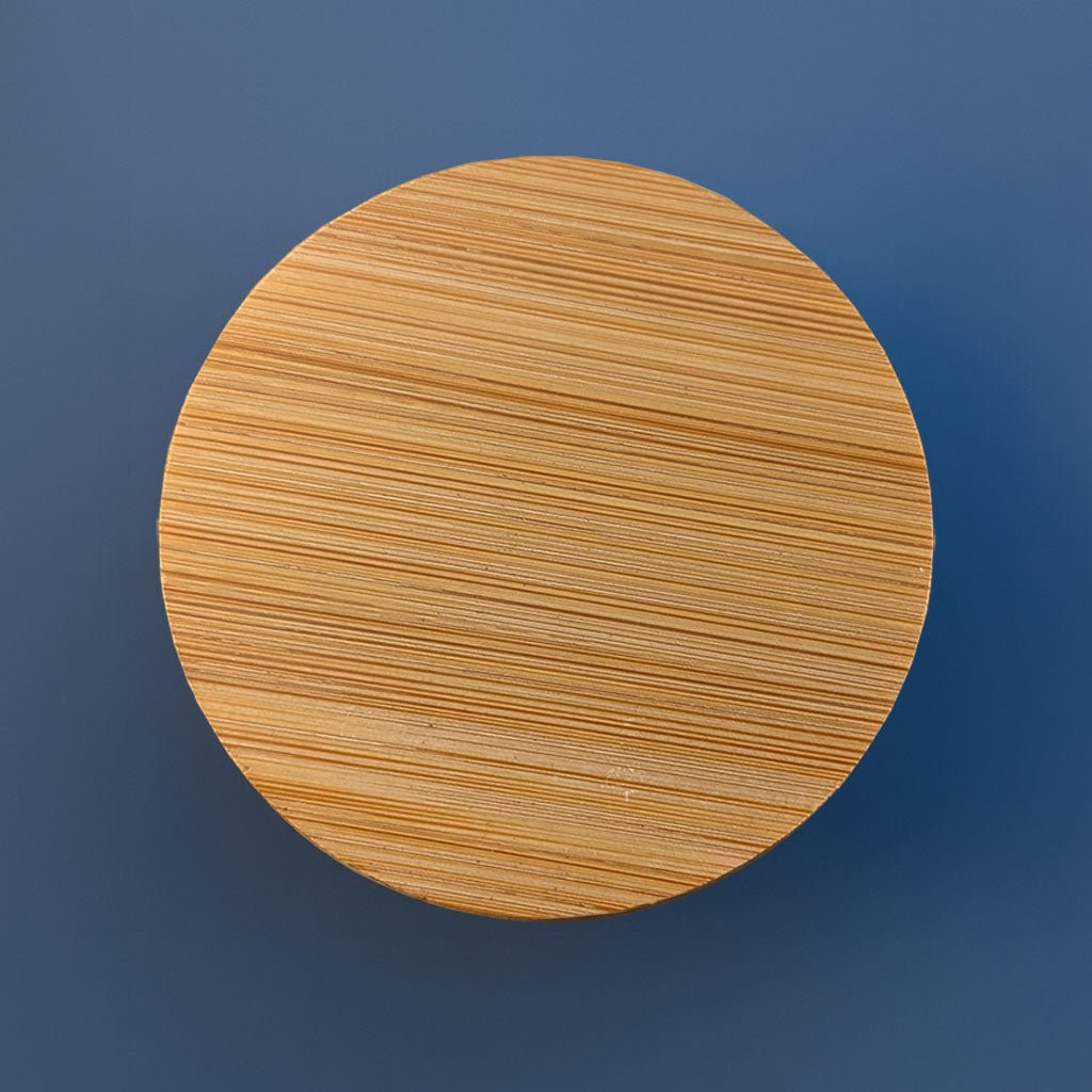 Plain circular blank bamboo storage container lid on blue background - customizable craft storage tin