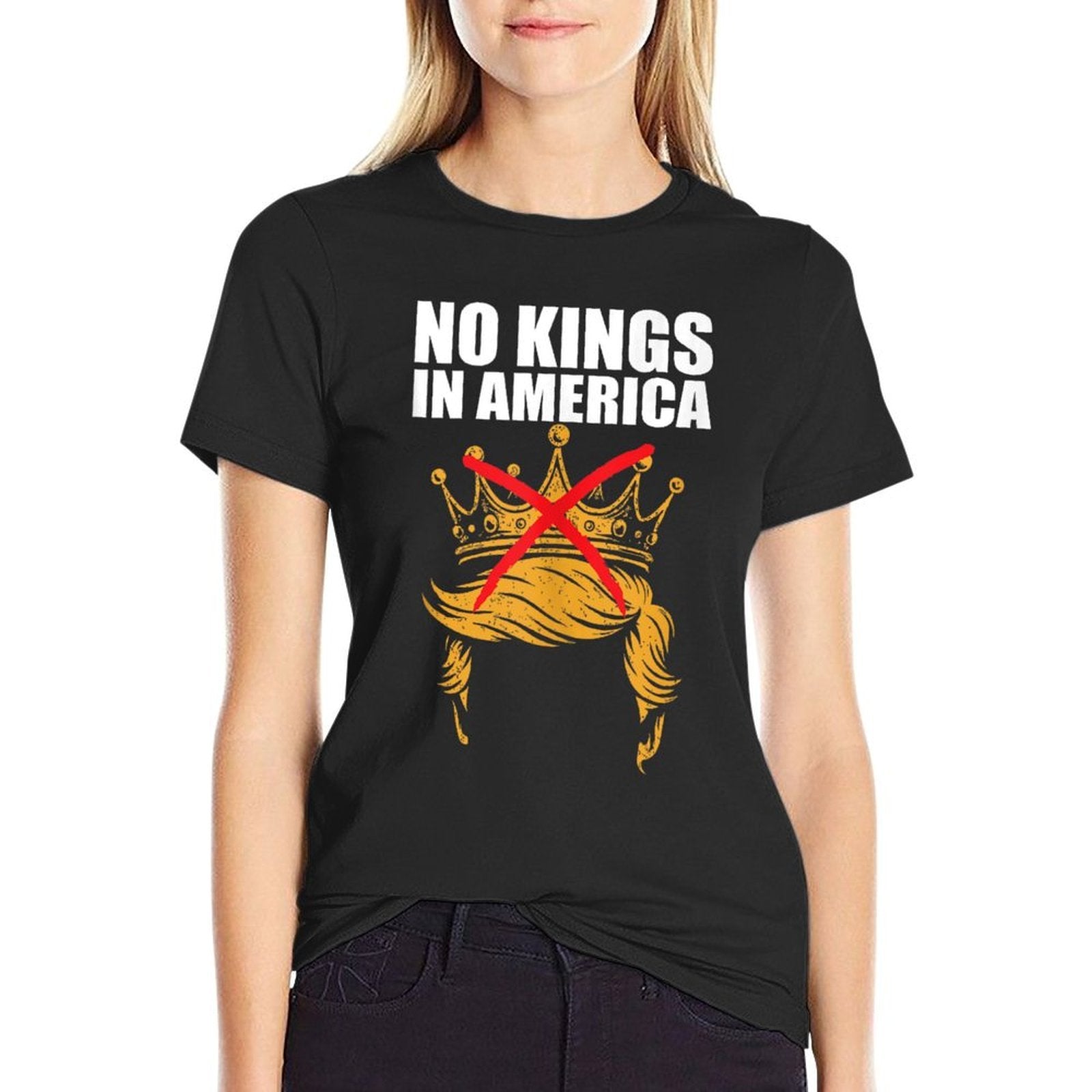 Person wearing a black t-shirt with 'No Kings in America' graphic design on a white background
