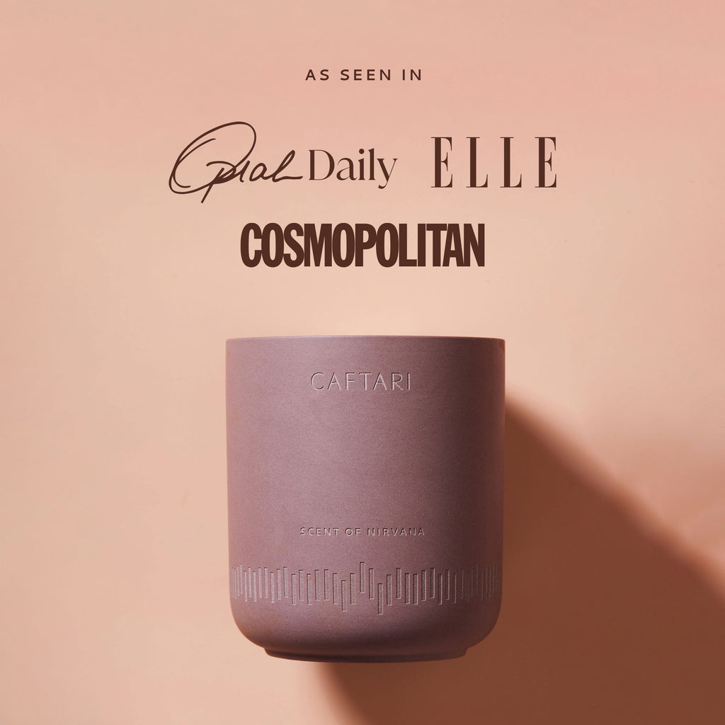 CAFTARI Scent of Nirvana candle on peach background featuring magazine titles