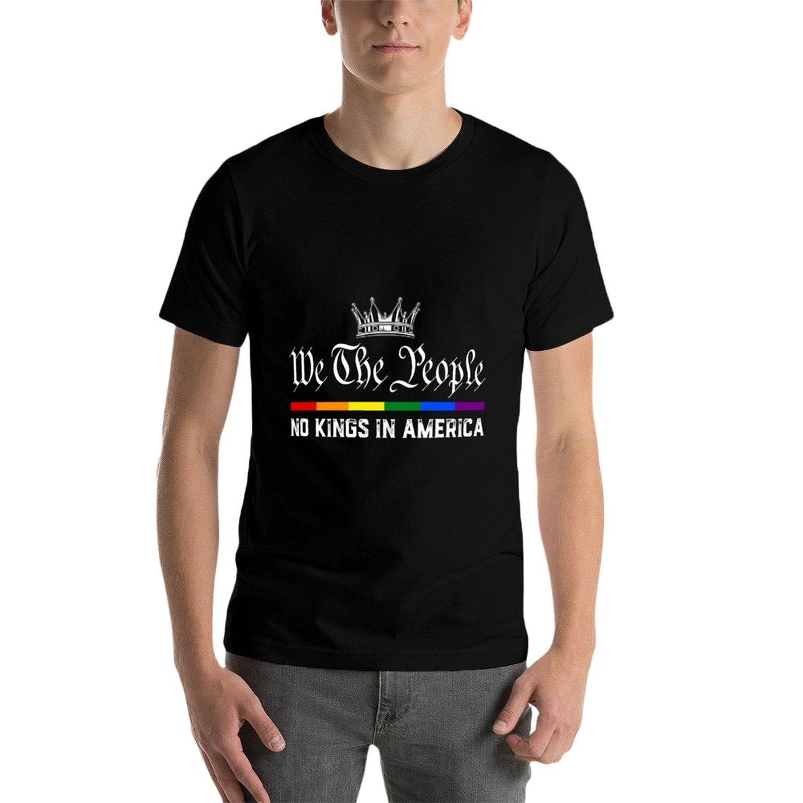 Youth wearing black lightweight t-shirt with 'We The People No Kings in America' text and rainbow flag design on white background
