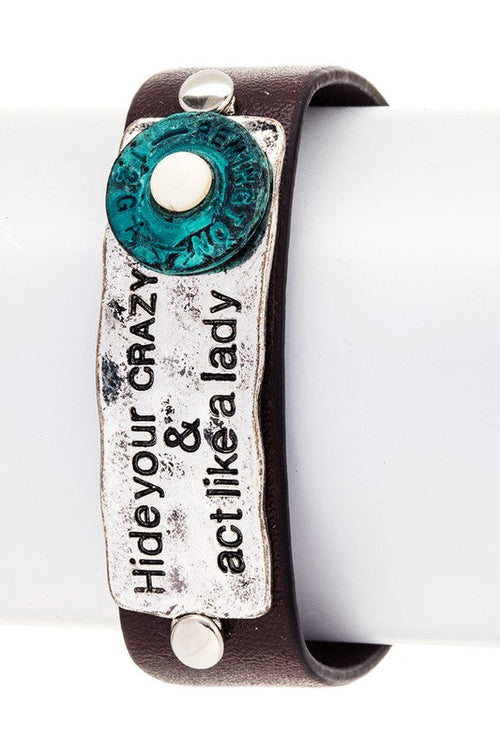 Close-up of engraved bullet detail on leather bracelet - statement jewelry for men and women