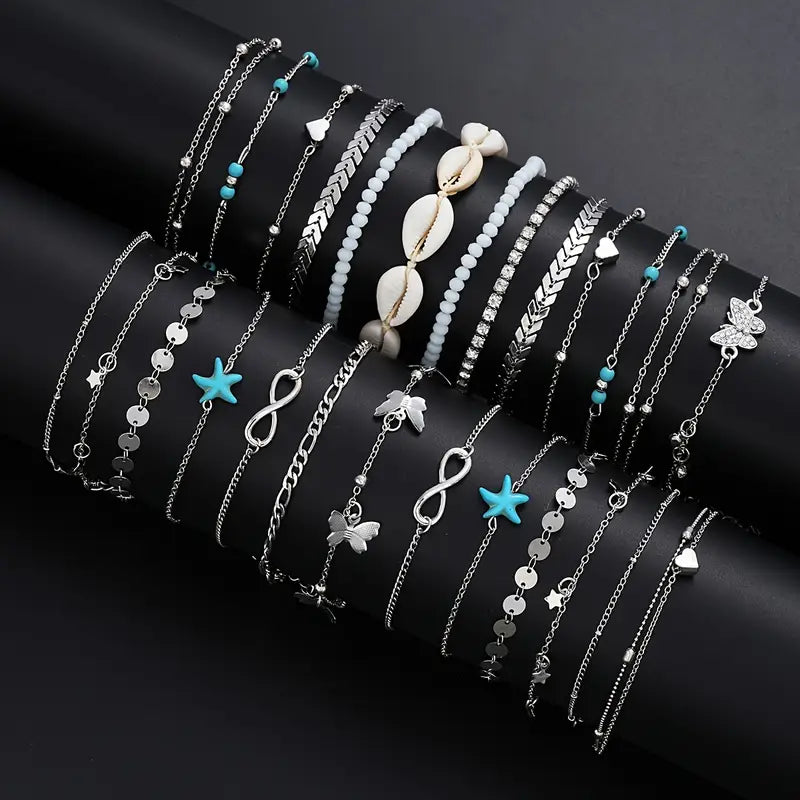 Collection of silver, shell and turquoise bracelets on dark background - variety bracelet set