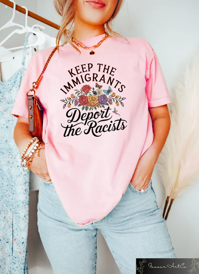 Woman wearing pink t-shirt with 'Keep the Immigrants Deport the Racists' statement in casual setting