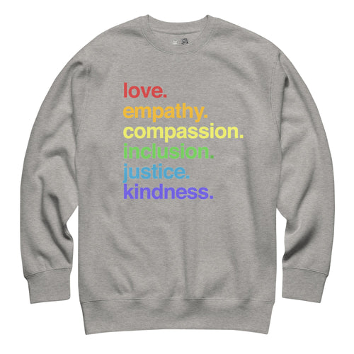 Gray crewneck sweatshirt with 'love empathy compassion inclusion justice kindness' text in colorful rainbow letters on white background - LGBTQ+ pride apparel by Kind Cotton