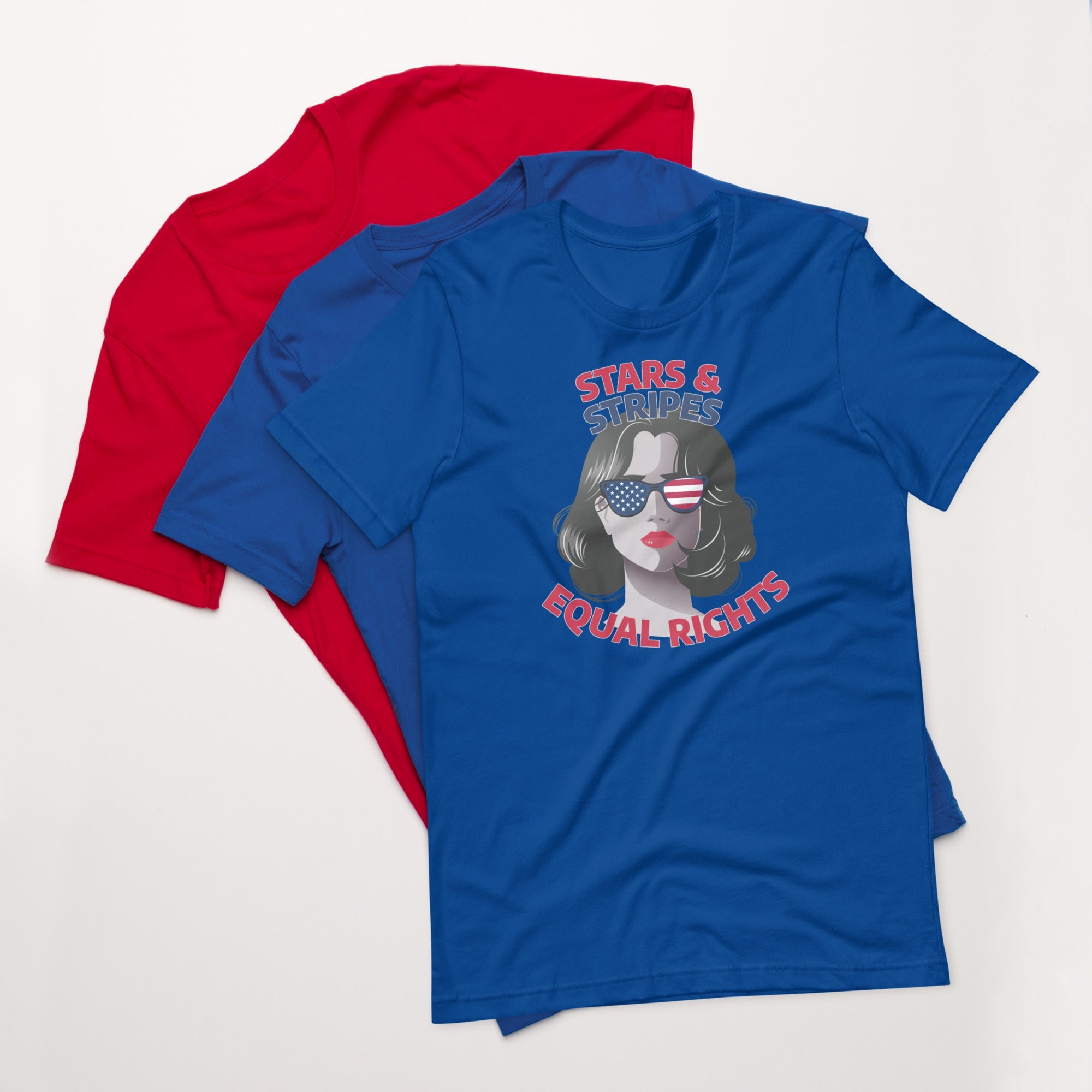 True royal blue unisex t-shirt with stars and stripes equal rights graphic design, displayed on top of fanned red and blue shirts on white background