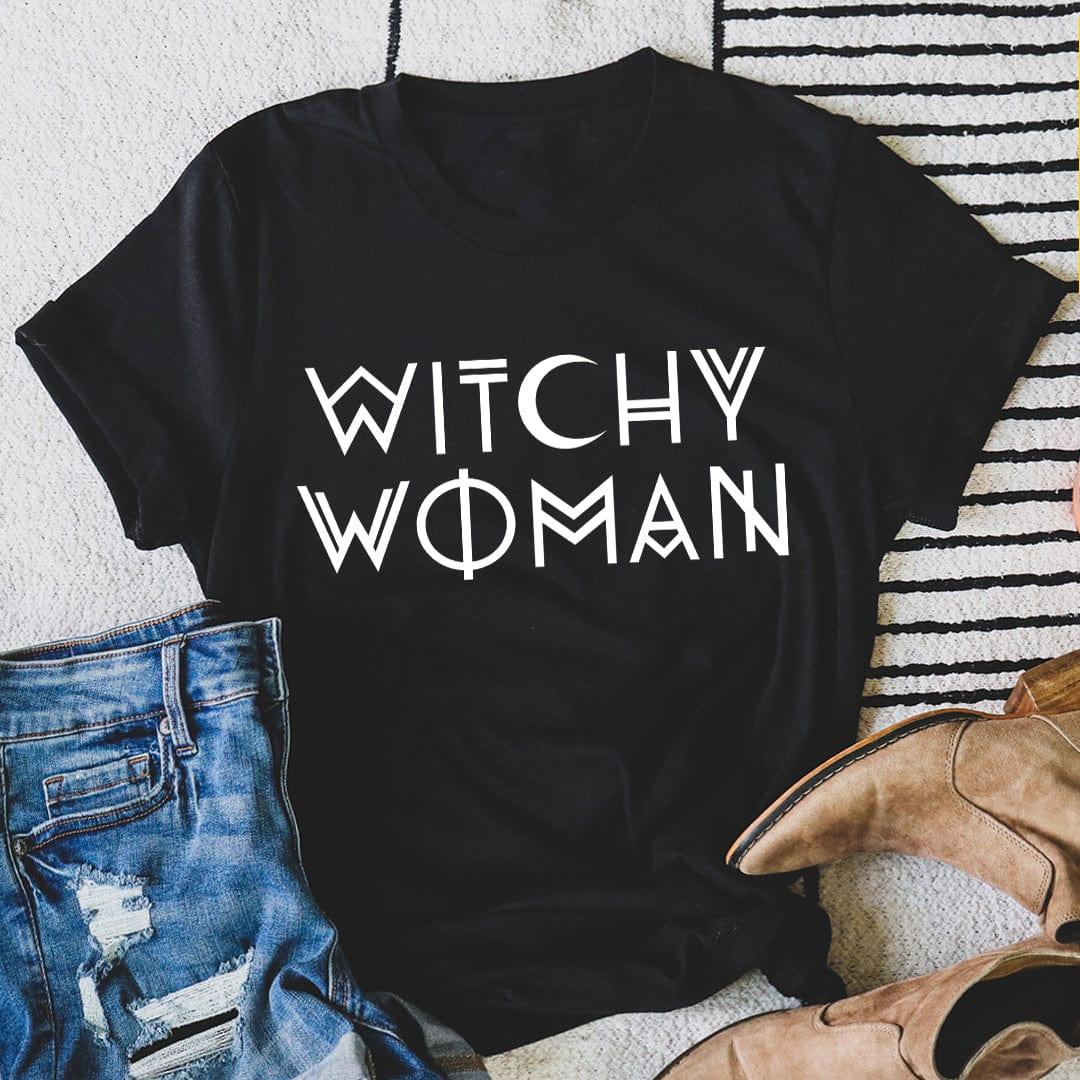 Black heather Witchy Woman graphic t-shirt on textured surface with jeans and boots - mystical feminine apparel